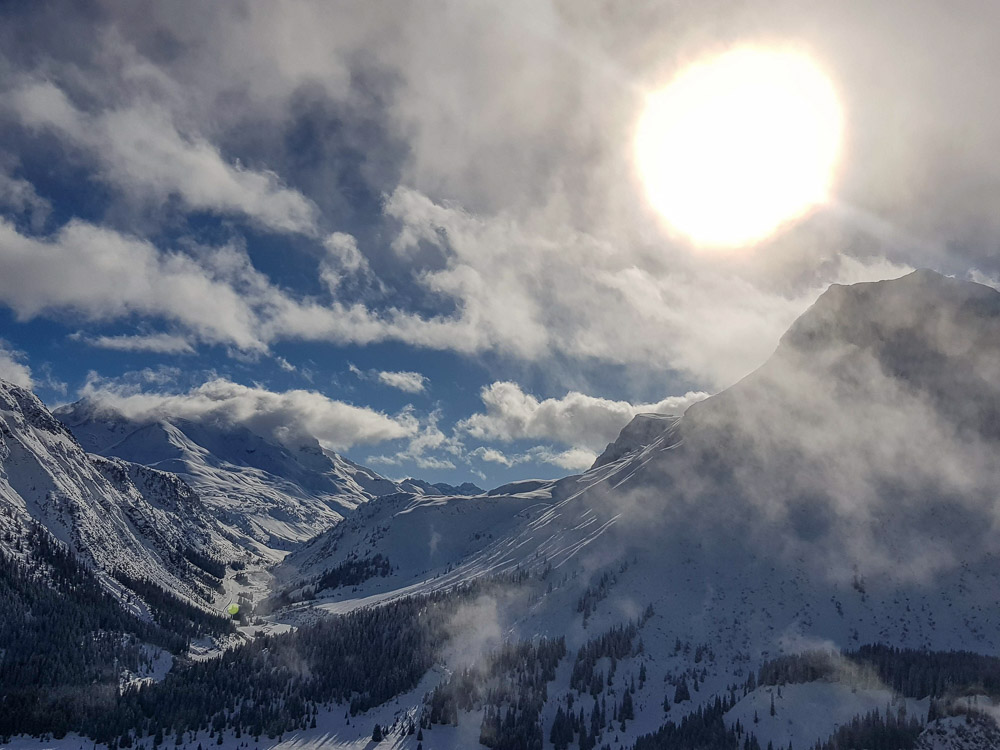 Sun over Alps with low hanging clouds